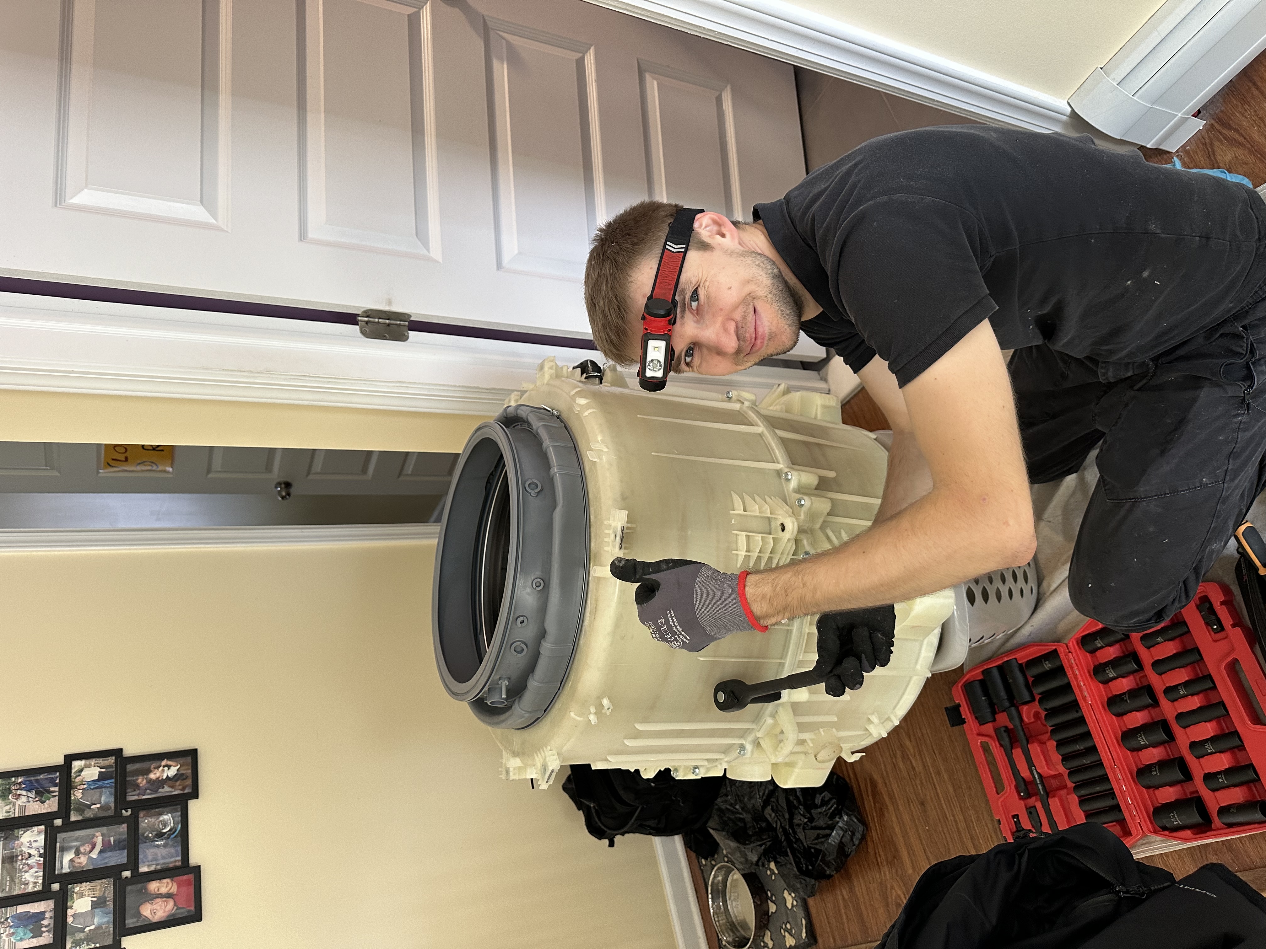 KLIA NY technician working on a washer